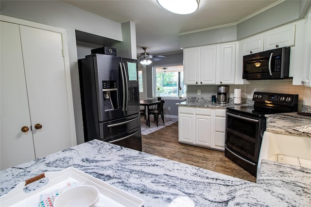 16003 Lone Shadow Trl, Stagecoach, TX 77355 - kitchen featuring stainless steel refrigerator with ice dispenser, range with two ovens, dark wood finished floors, white cabinetry, and light stone countertops