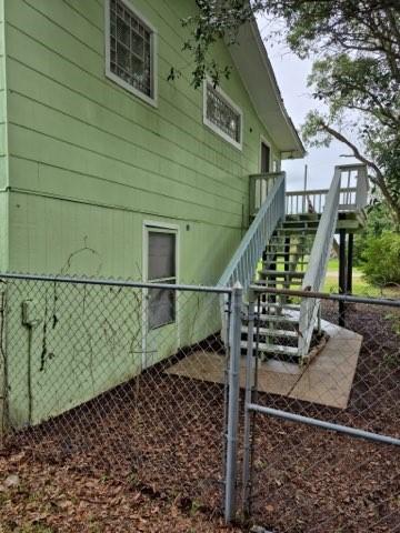 231 Bayshore Rd, Anahuac, TX 77514 - view of side of home featuring stairs and a gate