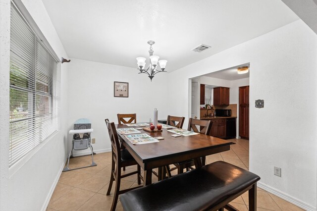 9207 Loren Ln, Houston, TX 77040 - dining area featuring light tile patterned floors, a chandelier, and baseboards
