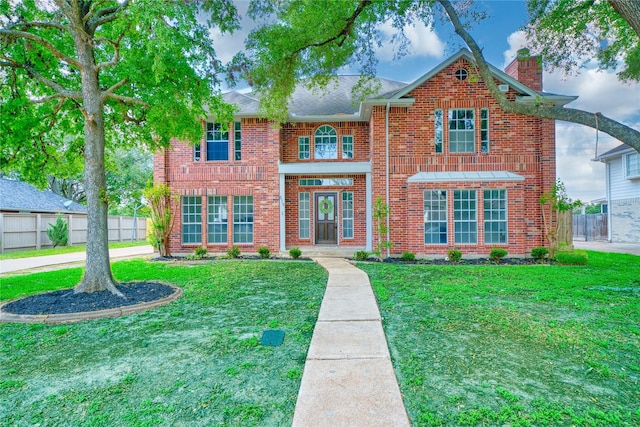 619 Green Belt Dr, Sugar Land, TX 77498 - view of front facade with a chimney and brick siding