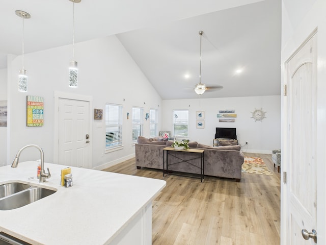 2403 S Bronte St, Rockport, TX 78382 - kitchen with a sink, high vaulted ceiling, a ceiling fan, hanging light fixtures, and baseboards