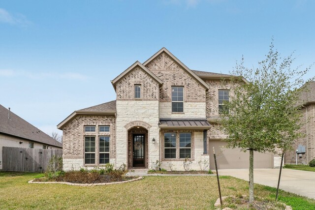 531 Campbell Dr, League City, TX 77573 - french country style house with driveway, an attached garage, a standing seam roof, and stone siding