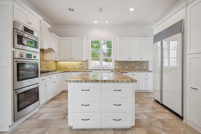 10918 Wickline Dr, Hunters Creek Village, TX 77024 - kitchen featuring appliances with stainless steel finishes, a sink, crown molding, white cabinets, and recessed lighting