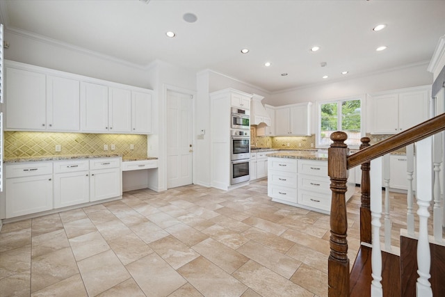 10918 Wickline Dr, Hunters Creek Village, TX 77024 - kitchen featuring ornamental molding, tasteful backsplash, recessed lighting, white cabinets, and light stone counters