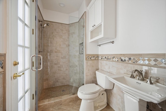 10918 Wickline Dr, Hunters Creek Village, TX 77024 - bathroom with toilet, a stall shower, a wainscoted wall, and a sink