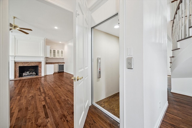 10918 Wickline Dr, Hunters Creek Village, TX 77024 - corridor featuring ornamental molding, dark wood-style floors, recessed lighting, stairs, and beverage cooler