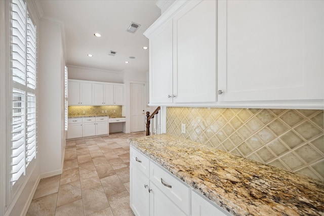 10918 Wickline Dr, Hunters Creek Village, TX 77024 - kitchen featuring decorative backsplash, light stone countertops, white cabinetry, recessed lighting, and baseboards
