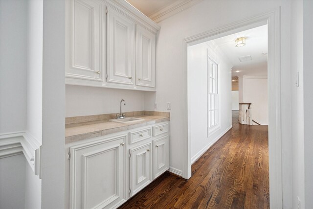 10918 Wickline Dr, Hunters Creek Village, TX 77024 - hall with a sink, crown molding, dark wood finished floors, and an upstairs landing