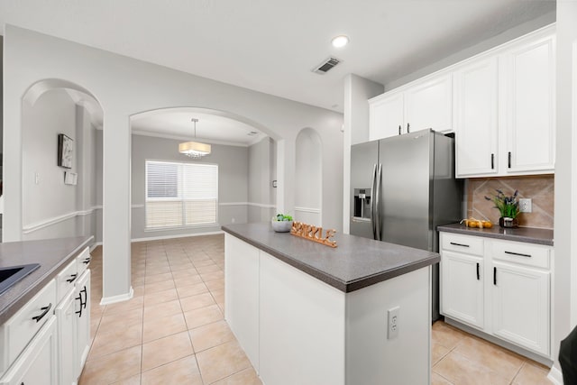 3639 Burning Palms Ct, Houston, TX 77042 - kitchen with dark countertops, arched walkways, light tile patterned flooring, tasteful backsplash, and recessed lighting