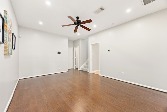 3639 Burning Palms Ct, Houston, TX 77042 - empty room with a ceiling fan, stairs, baseboards, wood finished floors, and recessed lighting