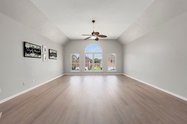 3639 Burning Palms Ct, Houston, TX 77042 - empty room featuring ceiling fan, wood finished floors, lofted ceiling, baseboards, and a textured ceiling