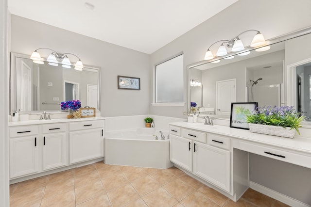 3639 Burning Palms Ct, Houston, TX 77042 - full bathroom featuring tile patterned flooring, two vanities, a garden tub, and walk in shower