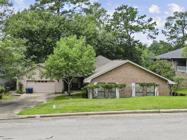 1925 E Lake Dr, Huntsville, TX 77340 - view of front of house with driveway, a front yard, a garage, and brick siding