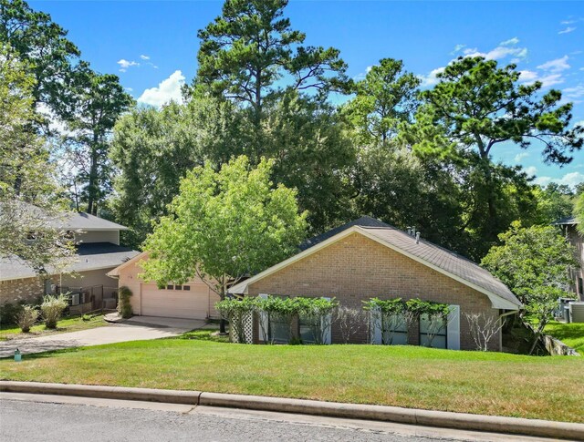 1925 E Lake Dr, Huntsville, TX 77340 - view of front of home with brick siding, a front lawn, and concrete driveway
