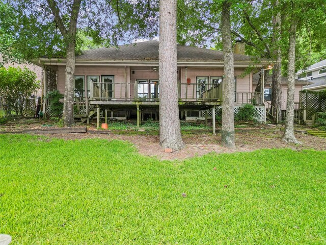1925 E Lake Dr, Huntsville, TX 77340 - back of property featuring a yard, a wooden deck, stairs, and a chimney