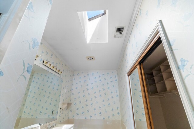 1925 E Lake Dr, Huntsville, TX 77340 - bathroom with wallpapered walls and crown molding
