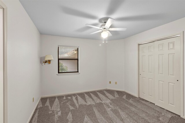 1925 E Lake Dr, Huntsville, TX 77340 - unfurnished bedroom featuring carpet, baseboards, a closet, and ceiling fan