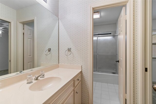 1925 E Lake Dr, Huntsville, TX 77340 - full bathroom with vanity, tile patterned flooring, enclosed tub / shower combo, and wallpapered walls