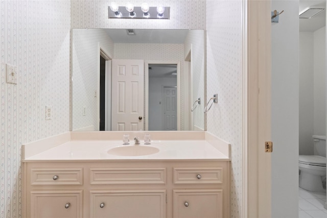 1925 E Lake Dr, Huntsville, TX 77340 - bathroom featuring wallpapered walls, toilet, vanity, and tile patterned flooring