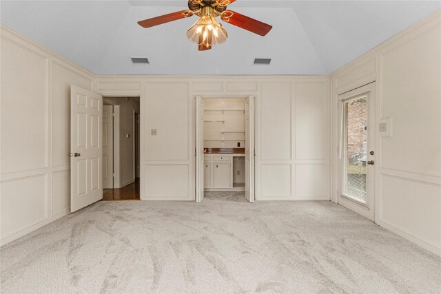 1925 E Lake Dr, Huntsville, TX 77340 - unfurnished bedroom featuring a decorative wall, vaulted ceiling, carpet floors, a ceiling fan, and access to outside