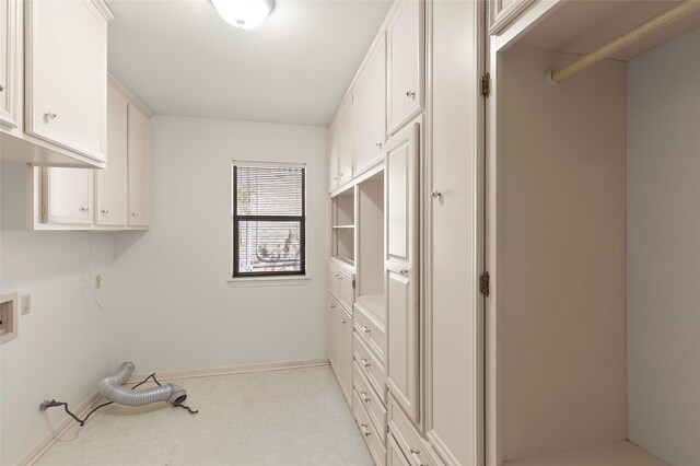 1925 E Lake Dr, Huntsville, TX 77340 - laundry room with hookup for a washing machine, cabinet space, baseboards, and light floors