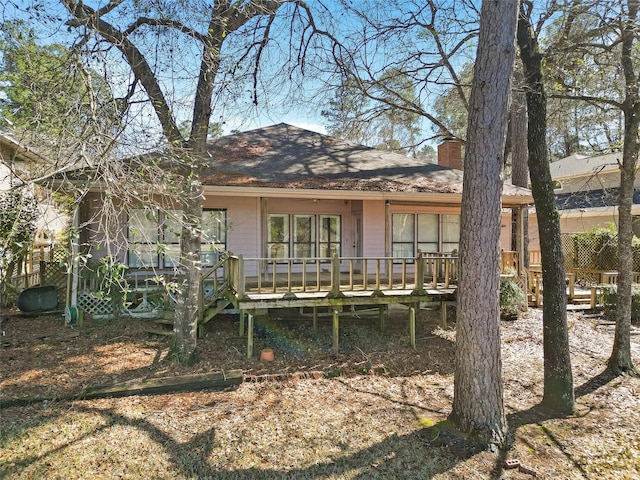 1925 E Lake Dr, Huntsville, TX 77340 - rear view of house with a chimney and a deck