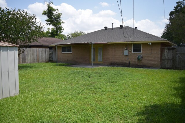 611 Glenvale Dr, Houston, TX 77060 - back of house featuring brick siding, roof with shingles, and a patio area