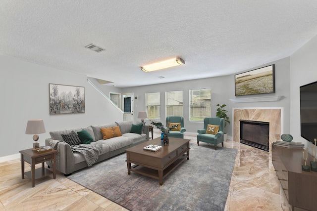 11622 Silent Elm St, Houston, TX 77044 - living room with a fireplace, a textured ceiling, and baseboards