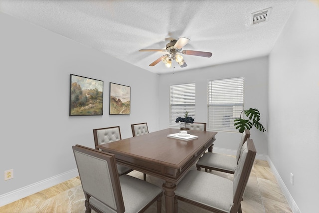 11622 Silent Elm St, Houston, TX 77044 - dining room with ceiling fan, baseboards, and a textured ceiling