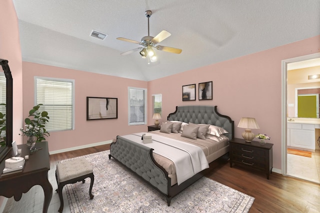 11622 Silent Elm St, Houston, TX 77044 - bedroom with lofted ceiling, dark wood finished floors, baseboards, connected bathroom, and ceiling fan