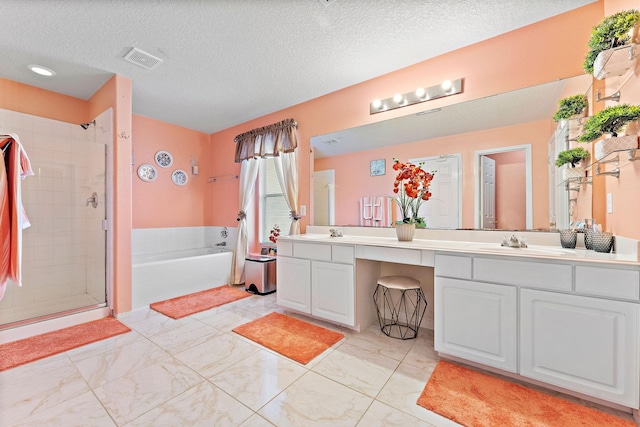 11622 Silent Elm St, Houston, TX 77044 - full bathroom featuring double vanity, a bath, a stall shower, a textured ceiling, and marble finish floors