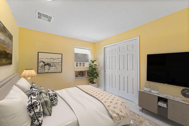 11622 Silent Elm St, Houston, TX 77044 - carpeted bedroom with a closet and a textured ceiling