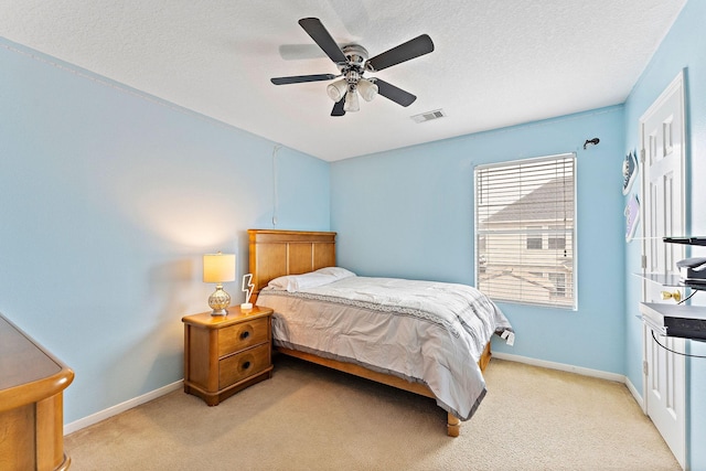 11622 Silent Elm St, Houston, TX 77044 - bedroom with light colored carpet, ceiling fan, baseboards, and a textured ceiling