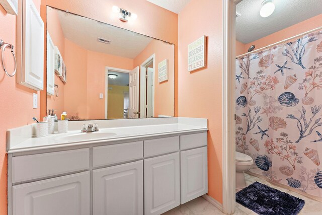 11622 Silent Elm St, Houston, TX 77044 - bathroom featuring marble look tile flooring, toilet, vanity, a textured ceiling, and a shower with shower curtain