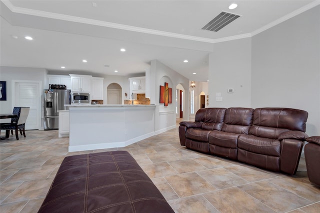 6003 Tarra Firma Dr, Spring, TX 77379 - living room featuring arched walkways, ornamental molding, and recessed lighting