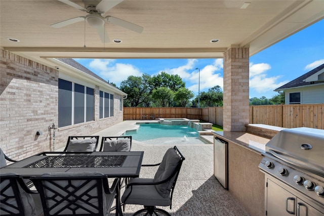 6003 Tarra Firma Dr, Spring, TX 77379 - view of pool with a fenced backyard, a patio area, a ceiling fan, exterior kitchen, and a pool with connected hot tub