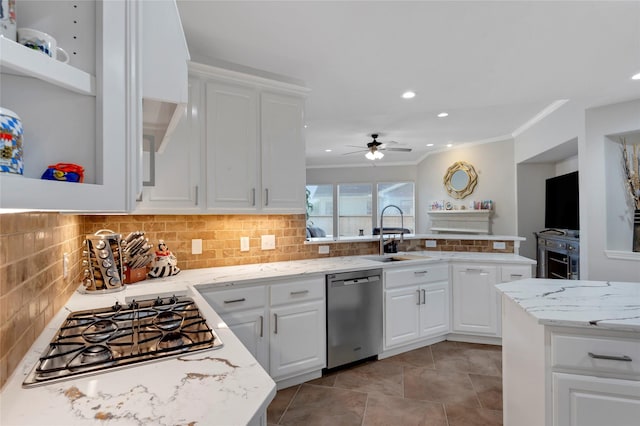 6003 Tarra Firma Dr, Spring, TX 77379 - kitchen with stainless steel appliances, ornamental molding, tasteful backsplash, a ceiling fan, and white cabinetry