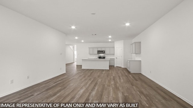 510 Belle Springs Ln, Conroe, TX 77301 - unfurnished living room featuring dark wood-type flooring, recessed lighting, and baseboards