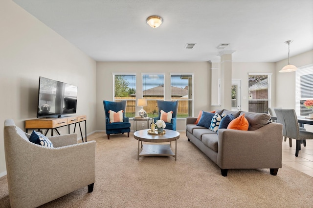 2943 Smokey Forest Ln, Spring, TX 77386 - living area with light carpet, decorative columns, and baseboards
