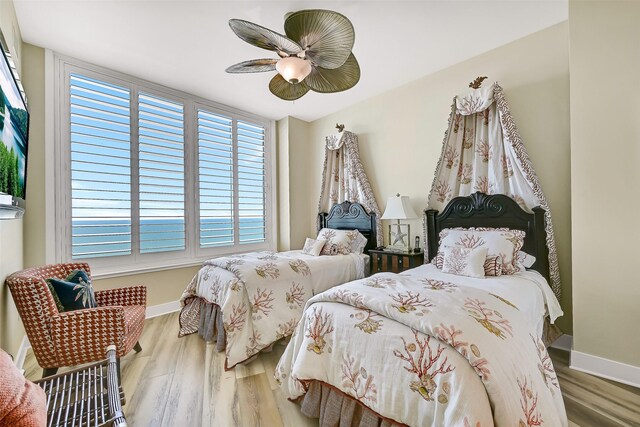 801 E Beach Dr Unit Bc2305, Galveston, TX 77550 - bedroom with wood finished floors, baseboards, and a ceiling fan
