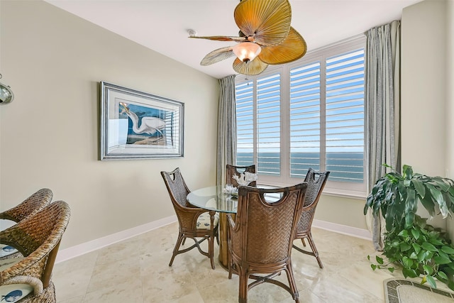 801 E Beach Dr Unit Bc2305, Galveston, TX 77550 - dining area featuring plenty of natural light, a ceiling fan, and baseboards