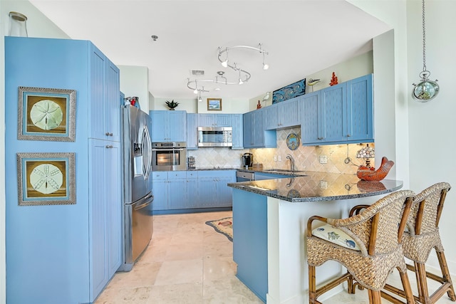 801 E Beach Dr Unit Bc2305, Galveston, TX 77550 - kitchen featuring stainless steel appliances, a sink, a peninsula, and blue cabinets
