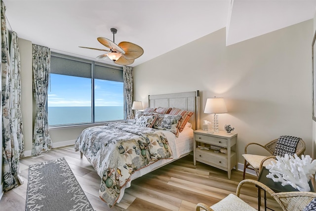 801 E Beach Dr Unit Bc2305, Galveston, TX 77550 - bedroom featuring wood finished floors, ceiling fan, and baseboards
