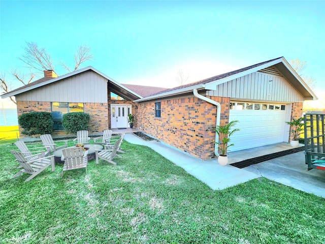 482 W Cattle Dr, Onalaska, TX 77360 - view of front of house with brick siding, an attached garage, concrete driveway, a front yard, and a chimney