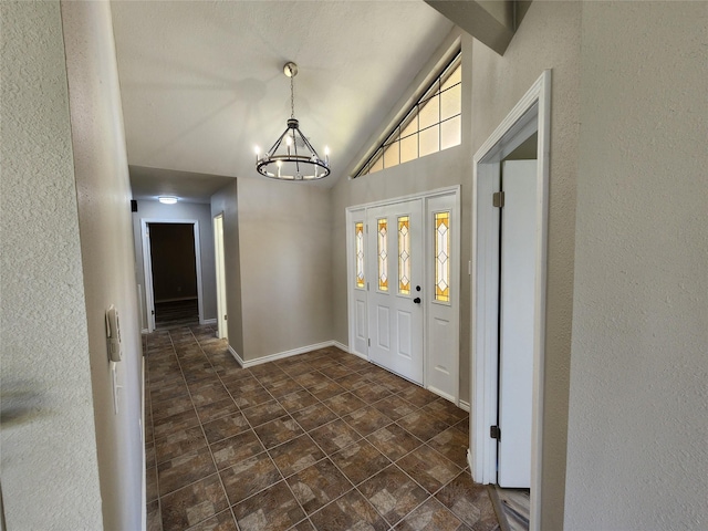 482 W Cattle Dr, Onalaska, TX 77360 - foyer with a chandelier, vaulted ceiling, and baseboards