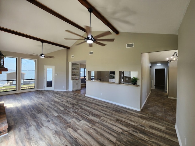 482 W Cattle Dr, Onalaska, TX 77360 - unfurnished living room featuring a ceiling fan, high vaulted ceiling, dark wood-type flooring, beamed ceiling, and a sink