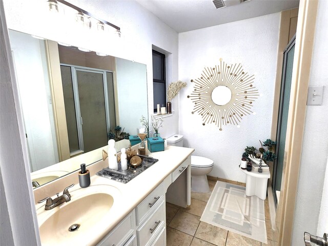 482 W Cattle Dr, Onalaska, TX 77360 - bathroom featuring a stall shower, toilet, vanity, tile patterned floors, and baseboards