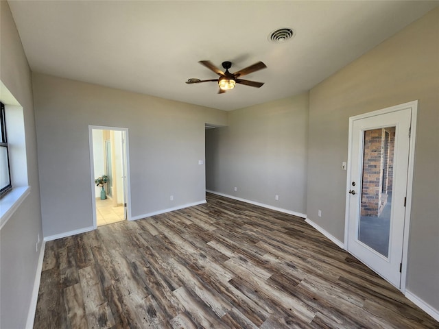482 W Cattle Dr, Onalaska, TX 77360 - spare room with dark wood-type flooring, a ceiling fan, and baseboards