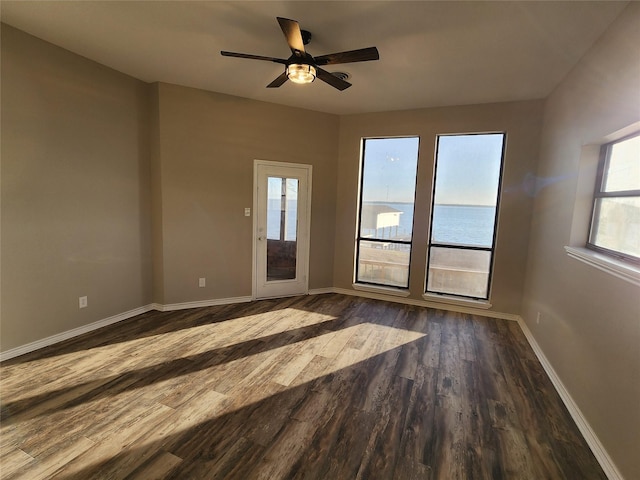 482 W Cattle Dr, Onalaska, TX 77360 - unfurnished room with dark wood-style flooring, baseboards, and ceiling fan