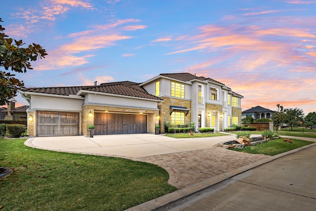 19111 N Frio River Cir, Cypress, TX 77433 - mediterranean / spanish home featuring concrete driveway, a garage, stone siding, and a yard